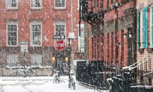 Flerfamiljshus i snöfall 