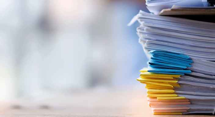 Pappershög på skrivbord