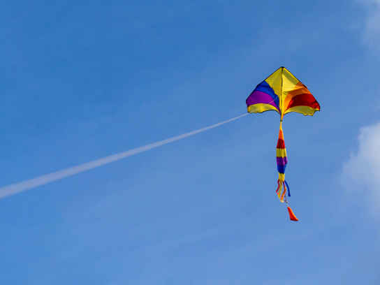 Gul och röd drake mot blå himmel