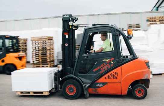 Orange truck som lastar